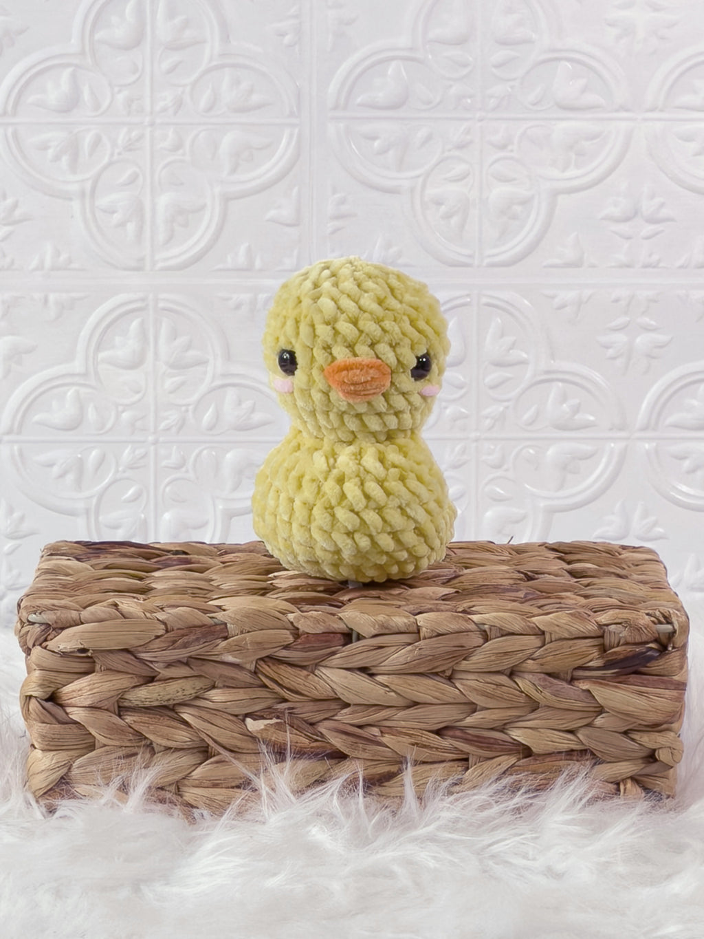 Handmade yellow rubber duck crochet plushie shown from the front