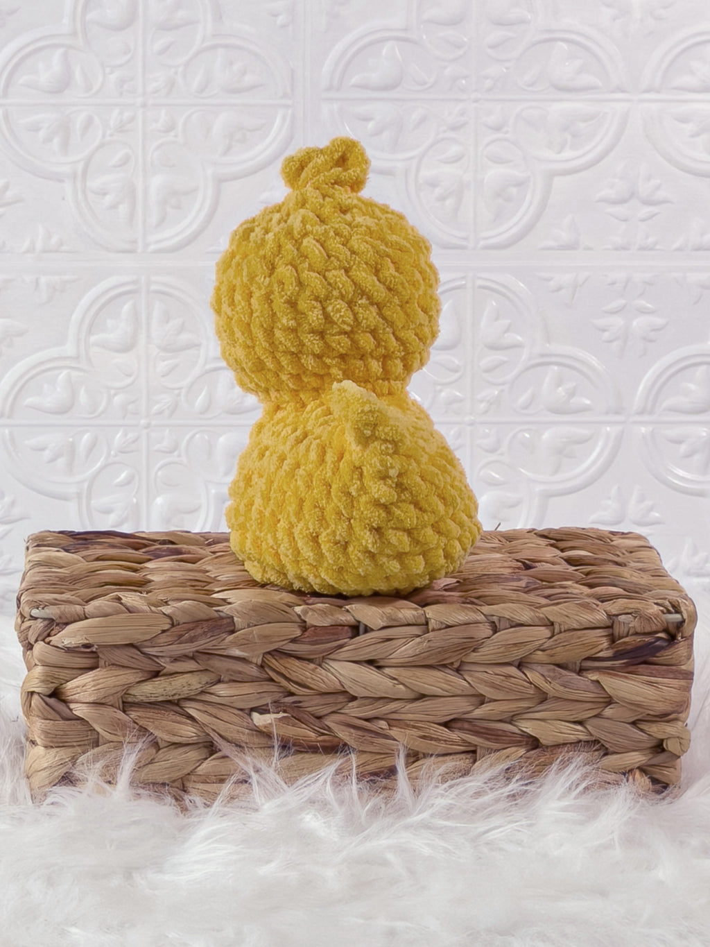 Handmade yellow, dark rubber duck crochet plushie shown from the back