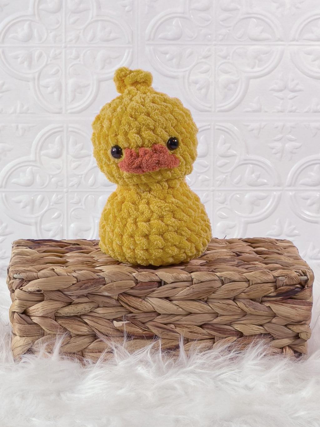 Handmade yellow, dark rubber duck crochet plushie shown from the front