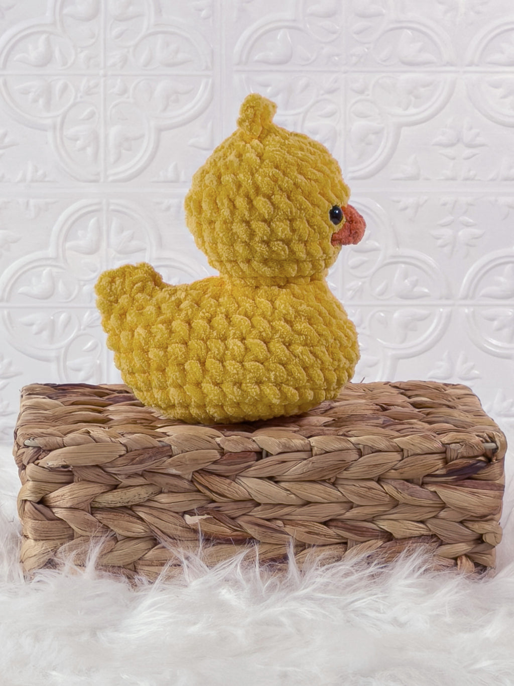 Handmade yellow, dark rubber duck crochet plushie shown from the side
