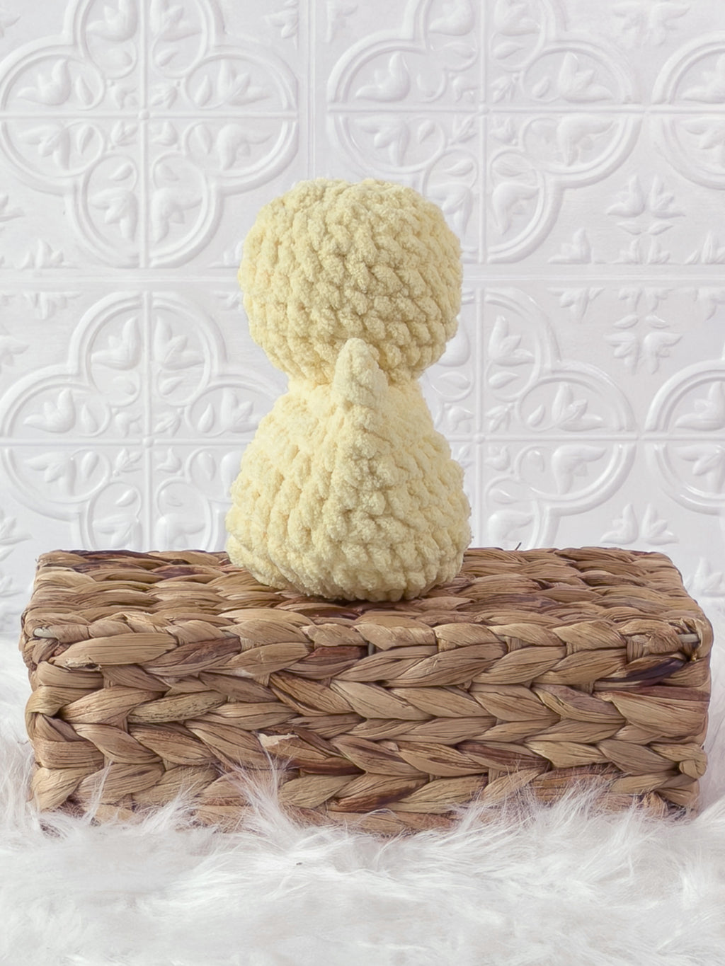 Handmade yellow, light rubber duck crochet plushie shown from the back