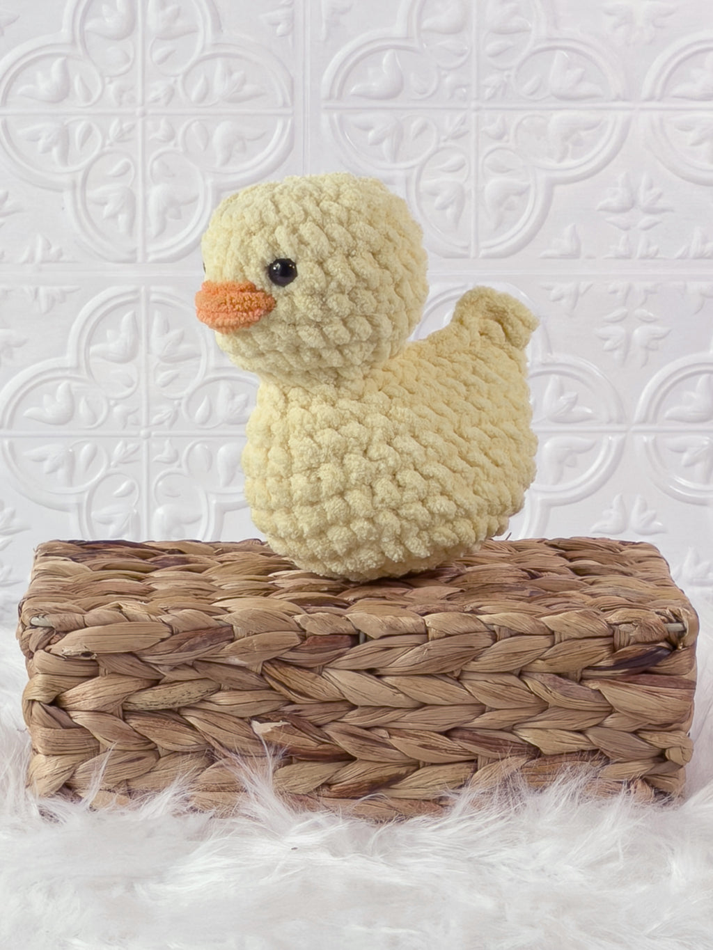 Handmade yellow, light rubber duck crochet plushie shown from the side