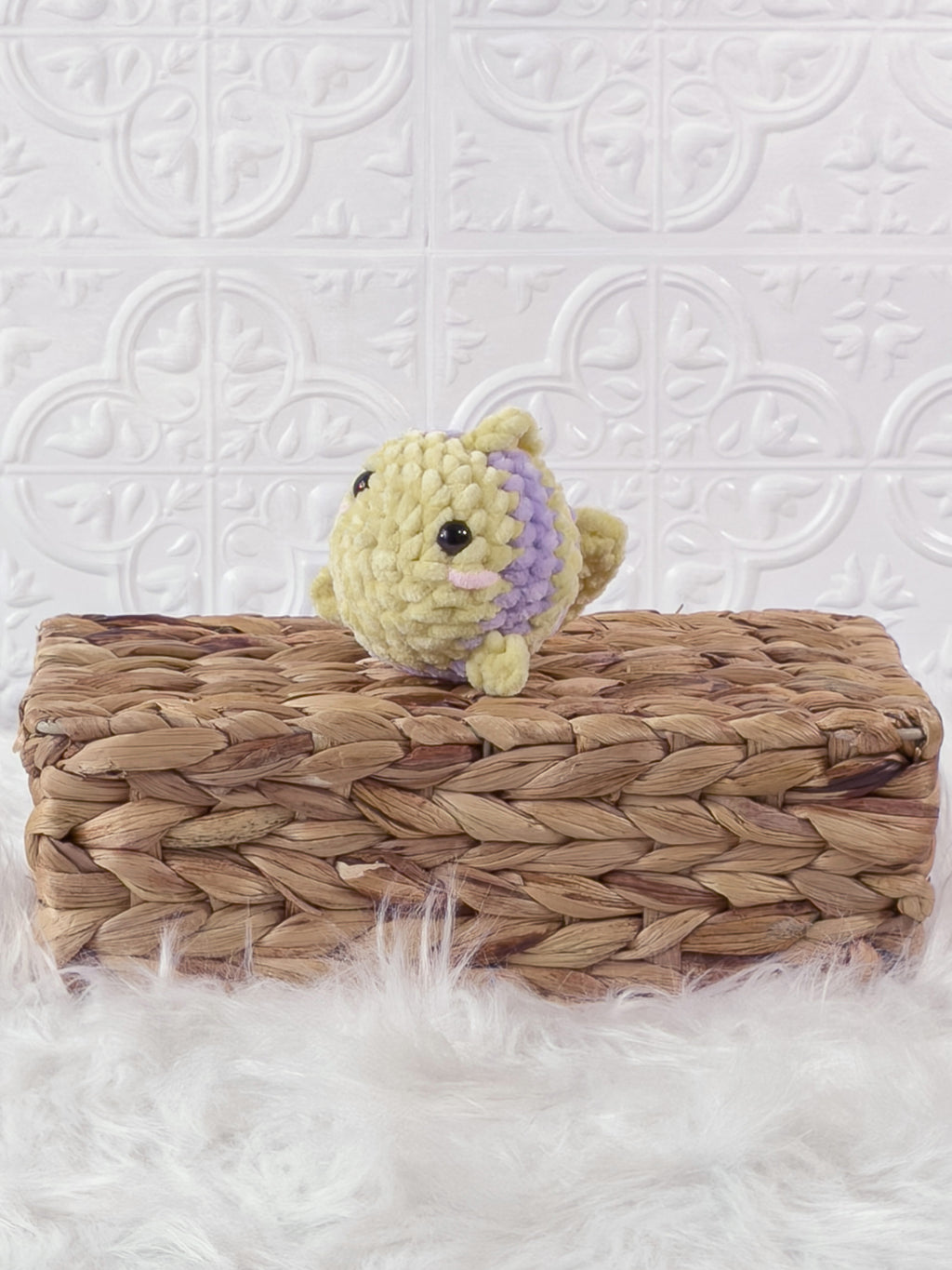 Small handmade fish crochet plushie shown from the front