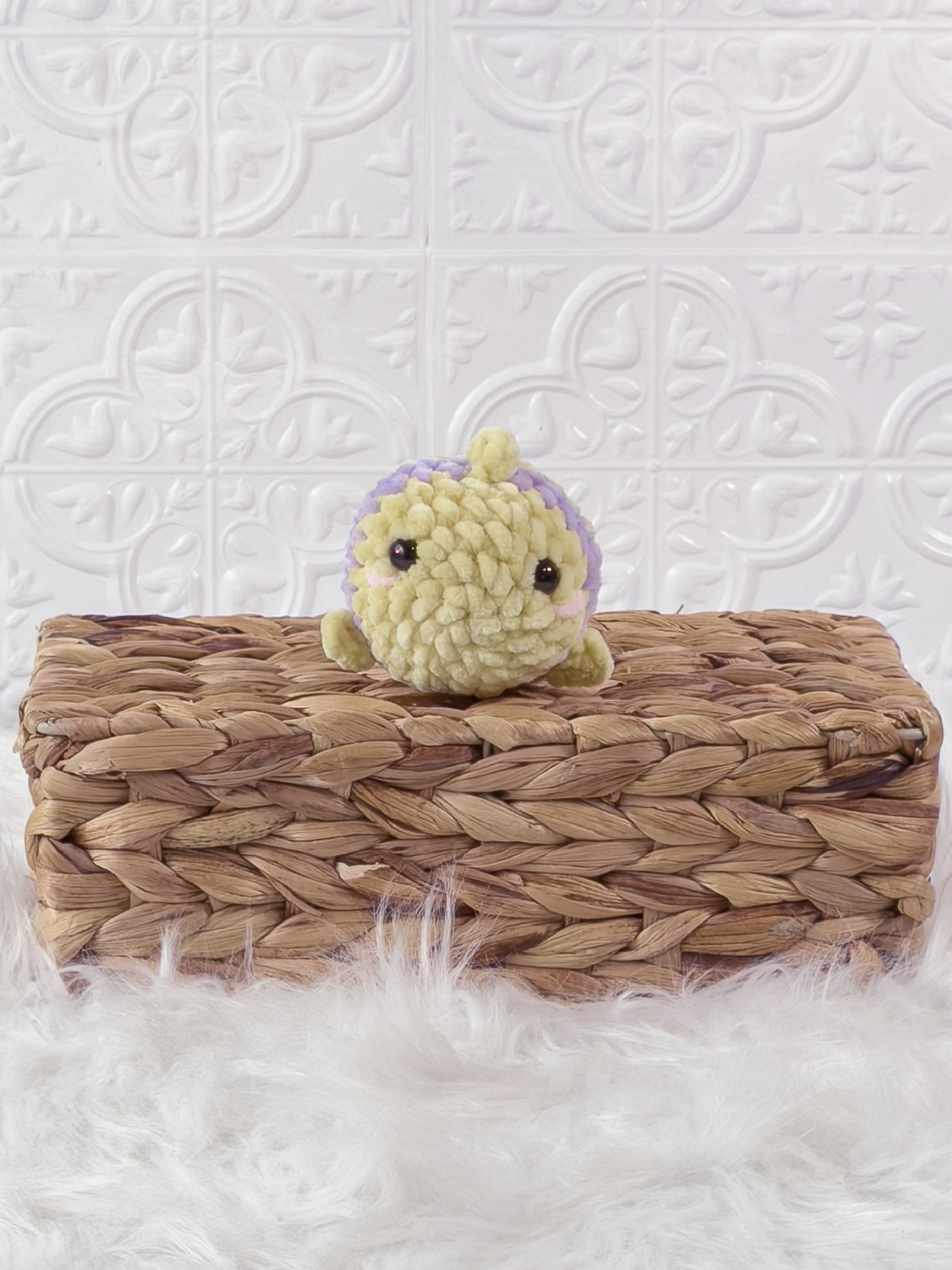 Handmade yellow, purple mini fish crochet plushie shown from the front