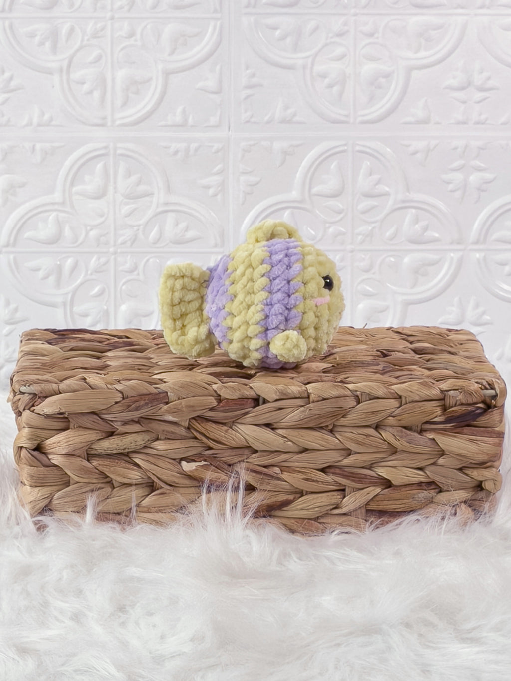 Handmade yellow, purple mini fish crochet plushie shown from the side